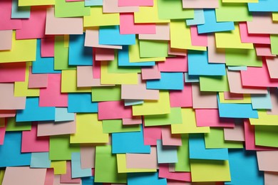 Photo of Colorful paper notes as background, closeup view