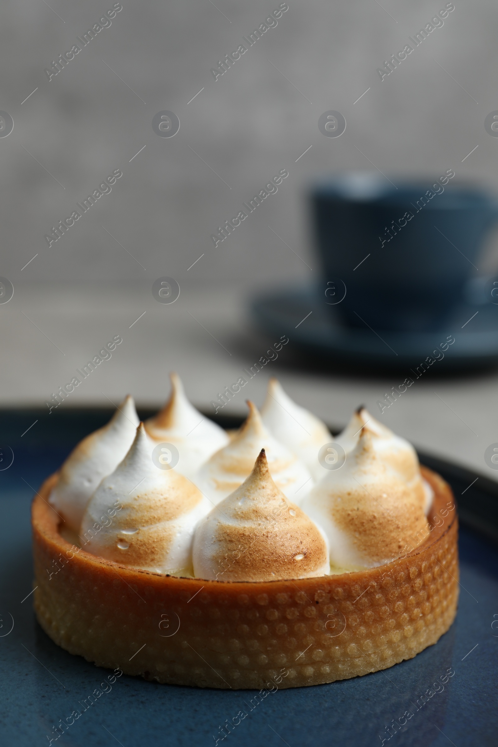 Photo of Tartlet with meringue on table, closeup and space for text. Delicious dessert