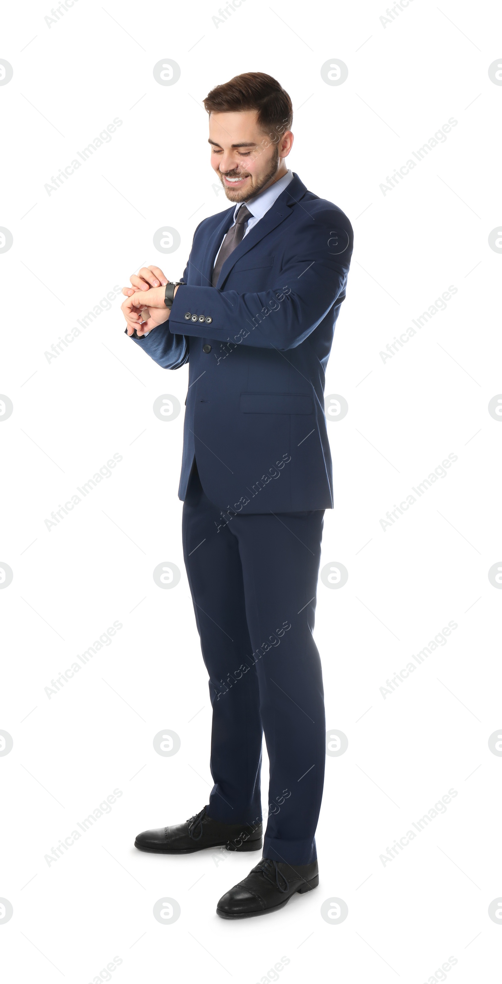 Photo of Full length portrait of businessman looking at wrist watch on white background