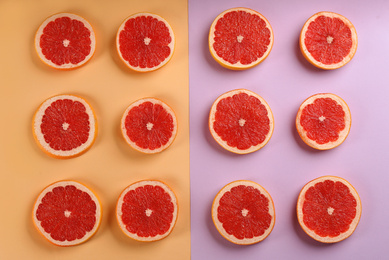 Photo of Flat lay composition with tasty ripe grapefruit slices on color background