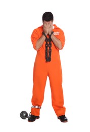 Prisoner in jumpsuit with chained hands and metal ball on white background
