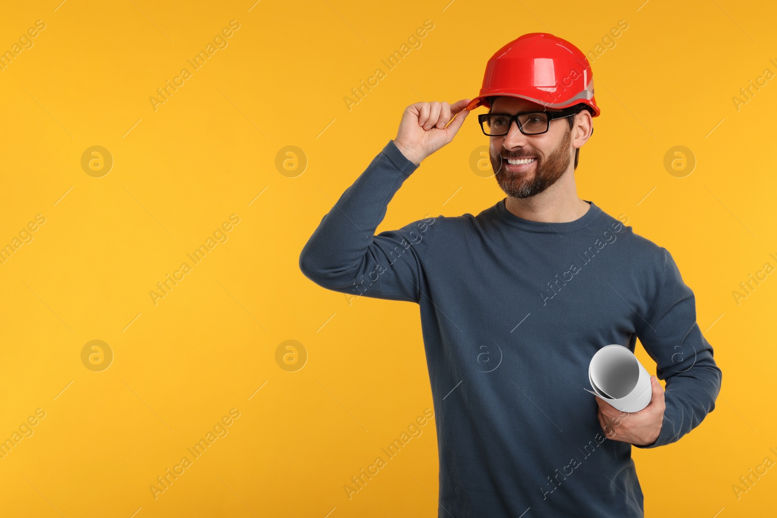 Photo of Architect in hard hat holding draft on orange background, space for text