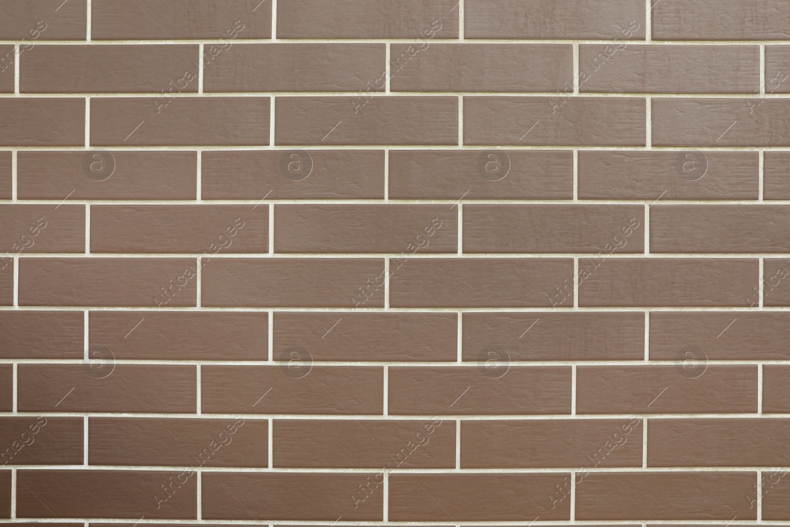 Photo of Texture of brown brick wall tiles as background