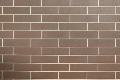 Photo of Texture of brown brick wall tiles as background