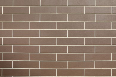 Texture of brown brick wall tiles as background