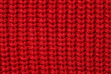 Texture of soft red knitted fabric as background, top view