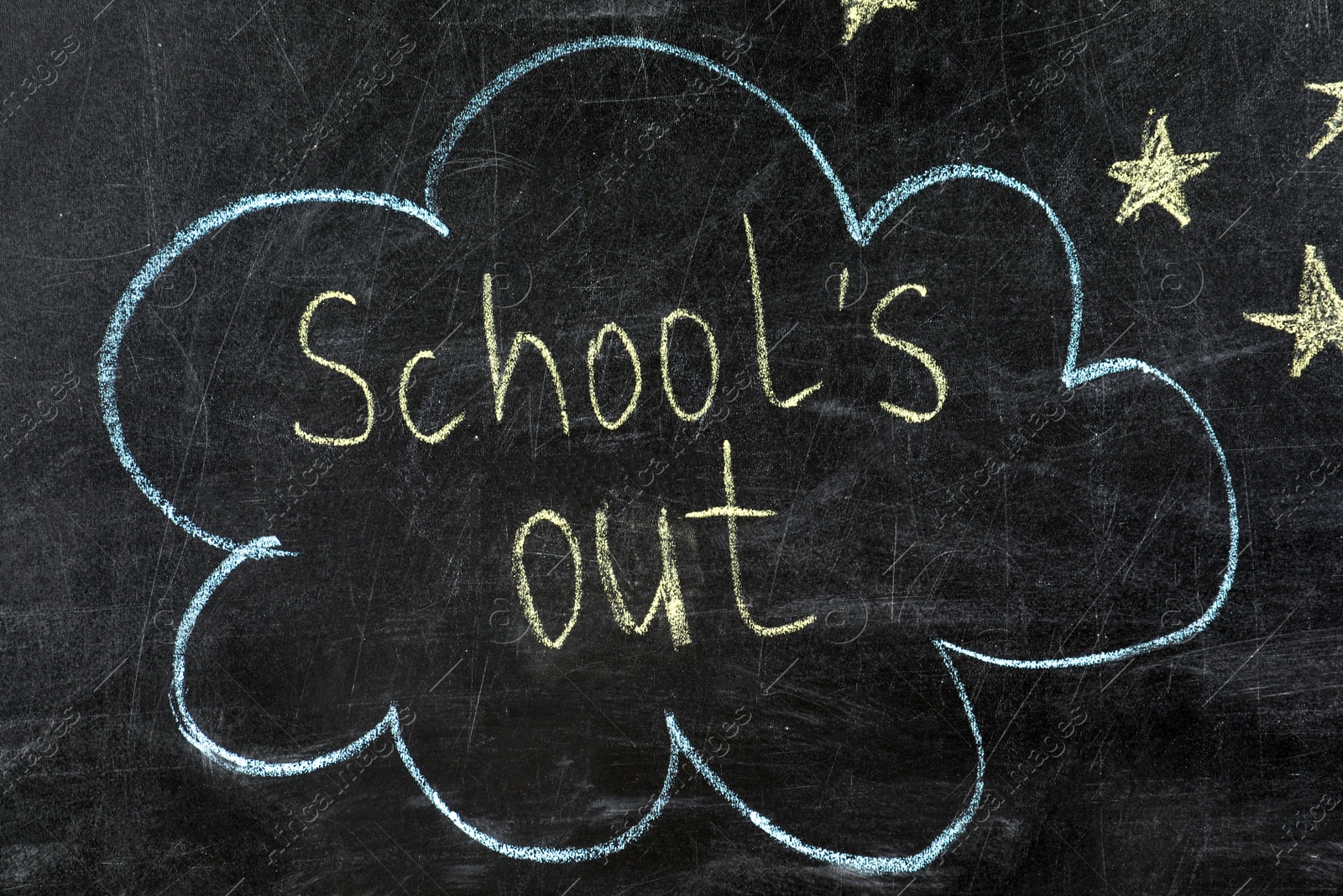 Photo of Text School's Out and drawings on black chalkboard. Summer holidays