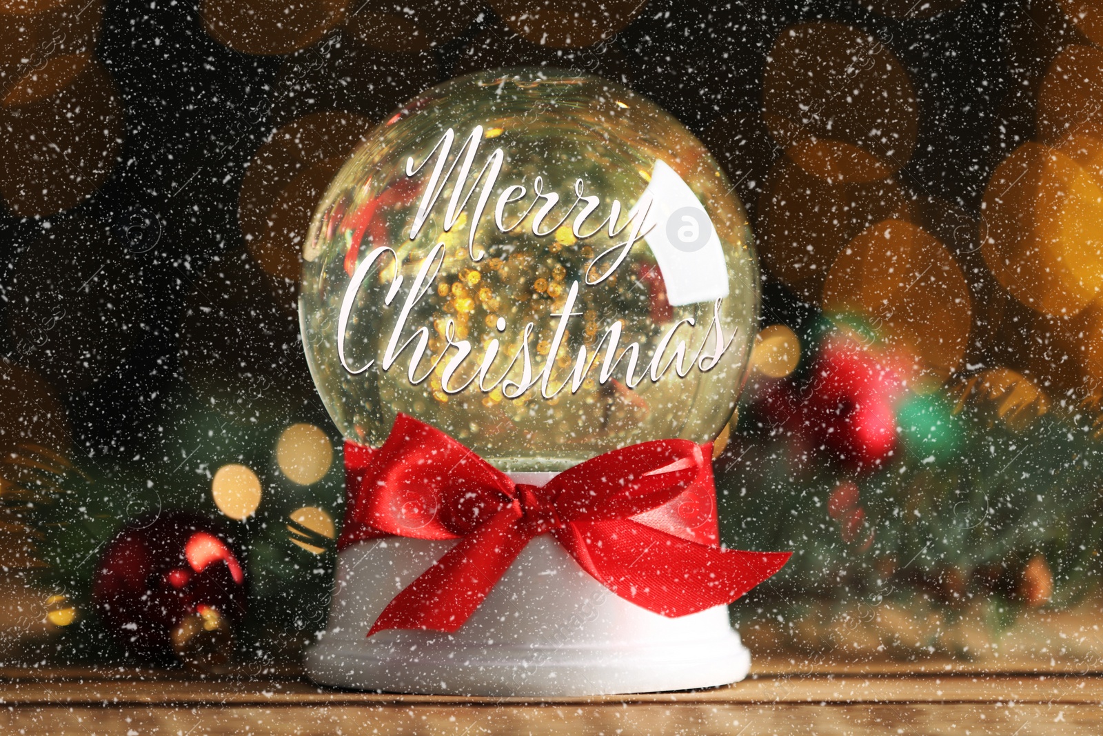 Beautiful snow globe with phrase Merry Christmas on wooden table, closeup Image of Beautiful snow globe with phrase Merry Christmas on wooden table, closeup