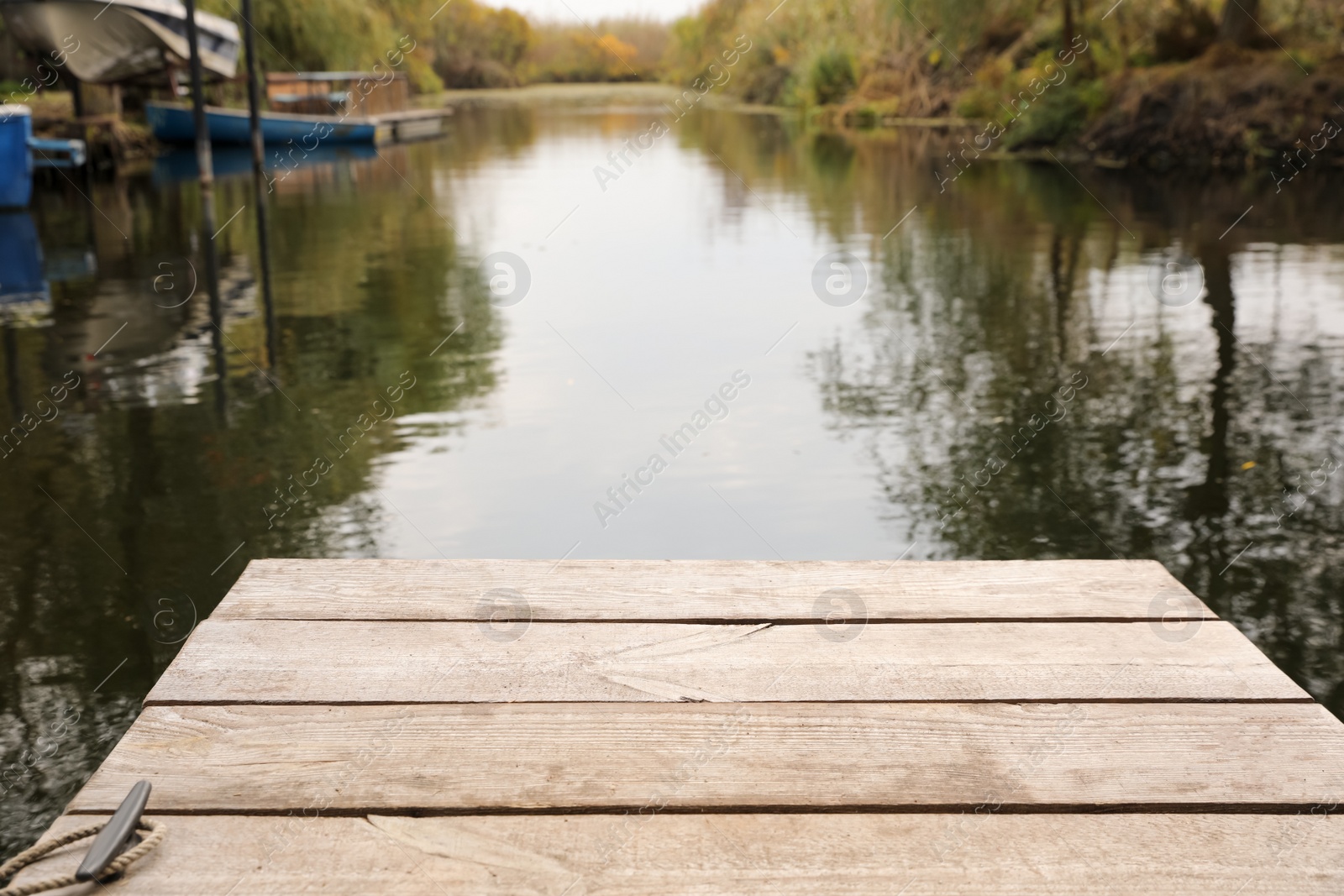 Photo of Beautiful wooden pier and lake on autumn day