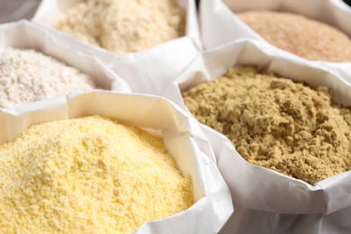 Photo of Paper bags with different types of flour, closeup