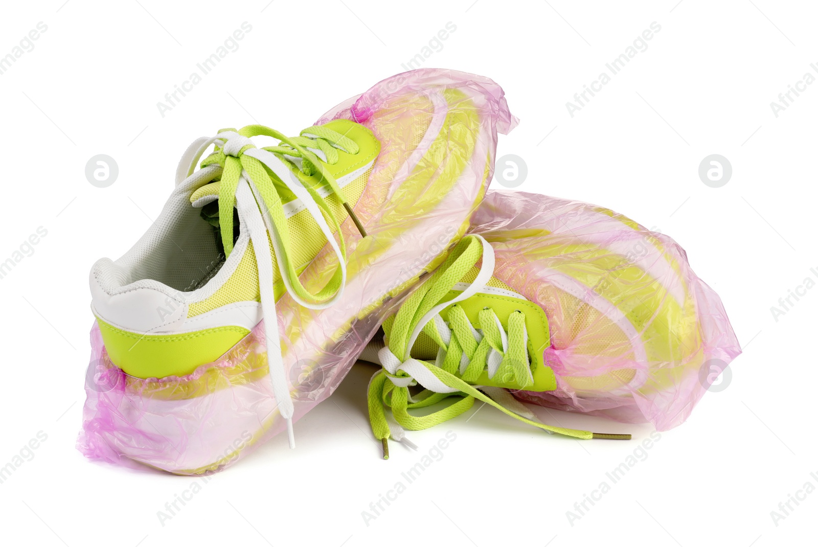 Photo of Sneakers in pink shoe covers isolated on white