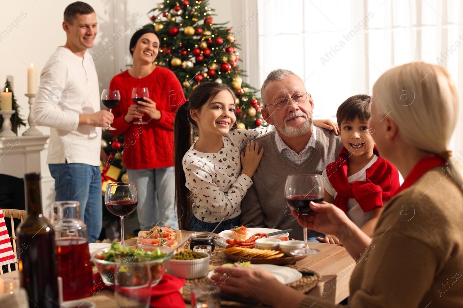 Photo of Happy family enjoying festive dinner at home. Christmas celebration