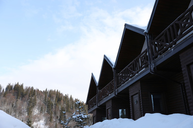 Beautiful winter landscape with hotel and snowy forest, low angle view