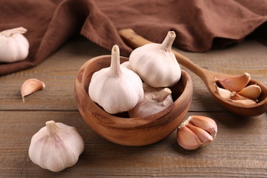 Photo of Fresh garlic on wooden table, closeup view