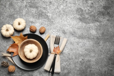 Festive table setting on grey background, flat lay with space for text. Thanksgiving Day celebration