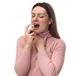 Woman using throat spray on white background