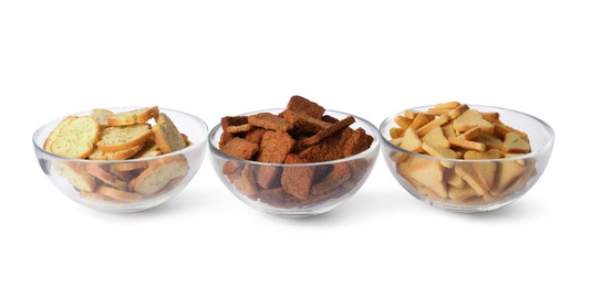 Different crispy rusks in bowls on white background