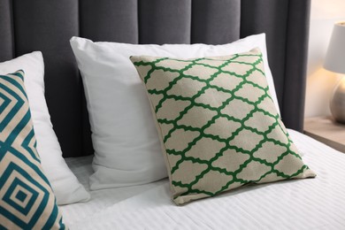 Photo of Soft pillows and bedsheet on bed at home