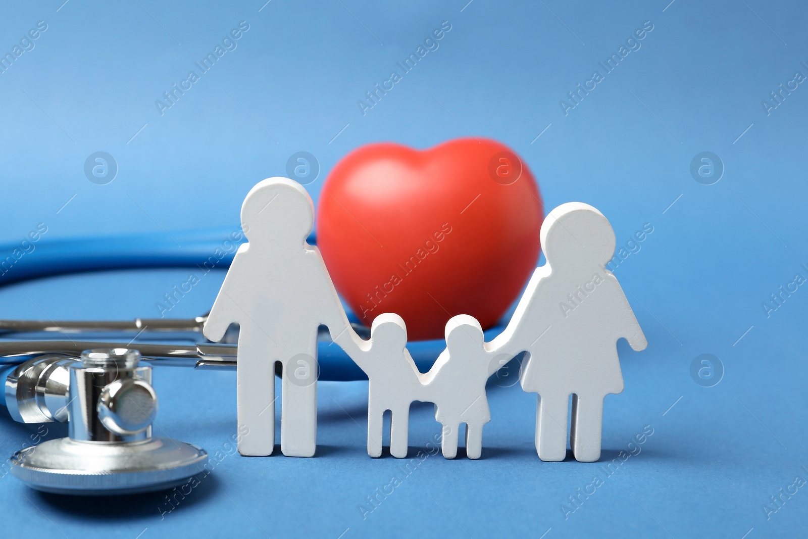 Photo of Family figure with stethoscope and heart on color background. Life insurance concept