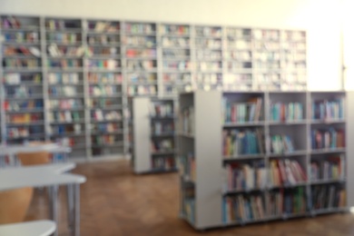 Photo of Blurred view of library interior with bookcases and tables