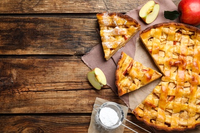 Traditional apple pie on wooden table, flat lay. Space for text