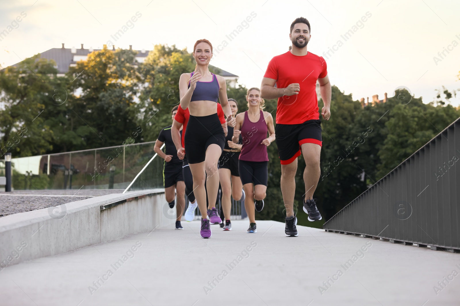 Photo of Group of people running outdoors. Active lifestyle