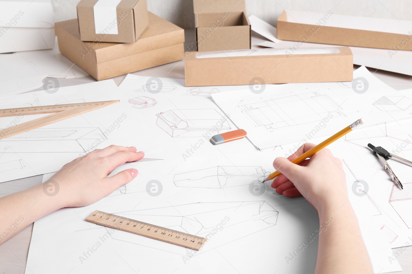 Photo of Woman creating packaging design at table, closeup