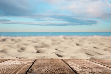 Wooden surface on sandy beach near ocean
