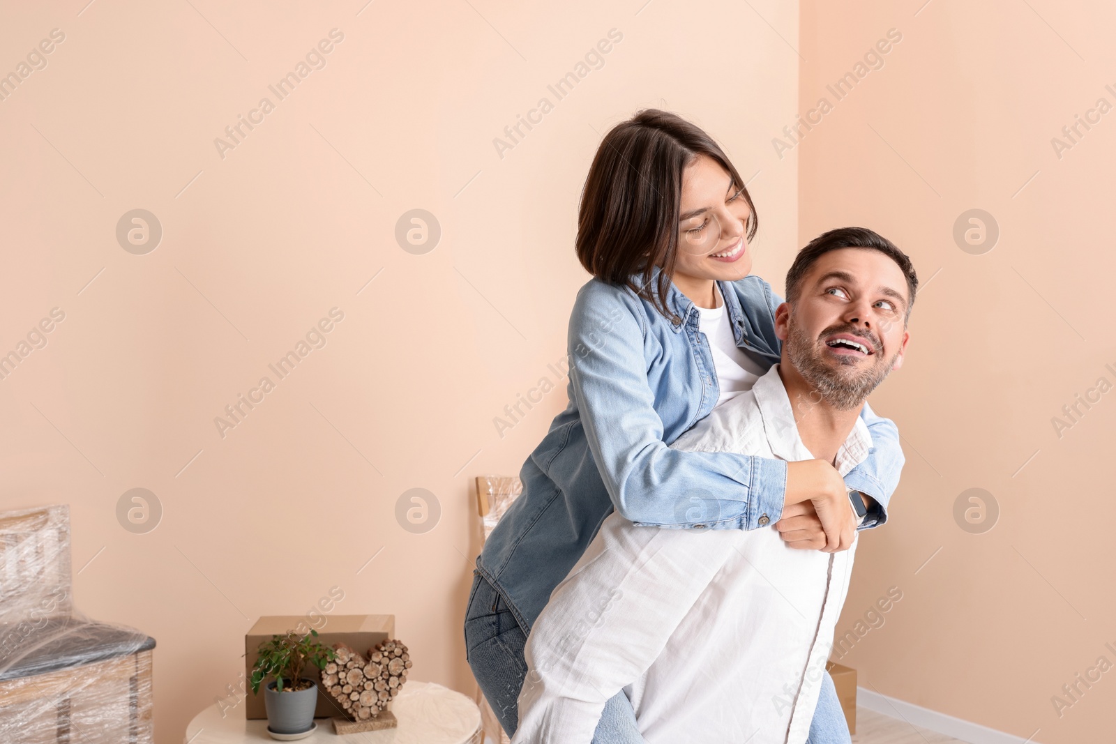 Photo of Happy couple having fun in new apartment. Moving day