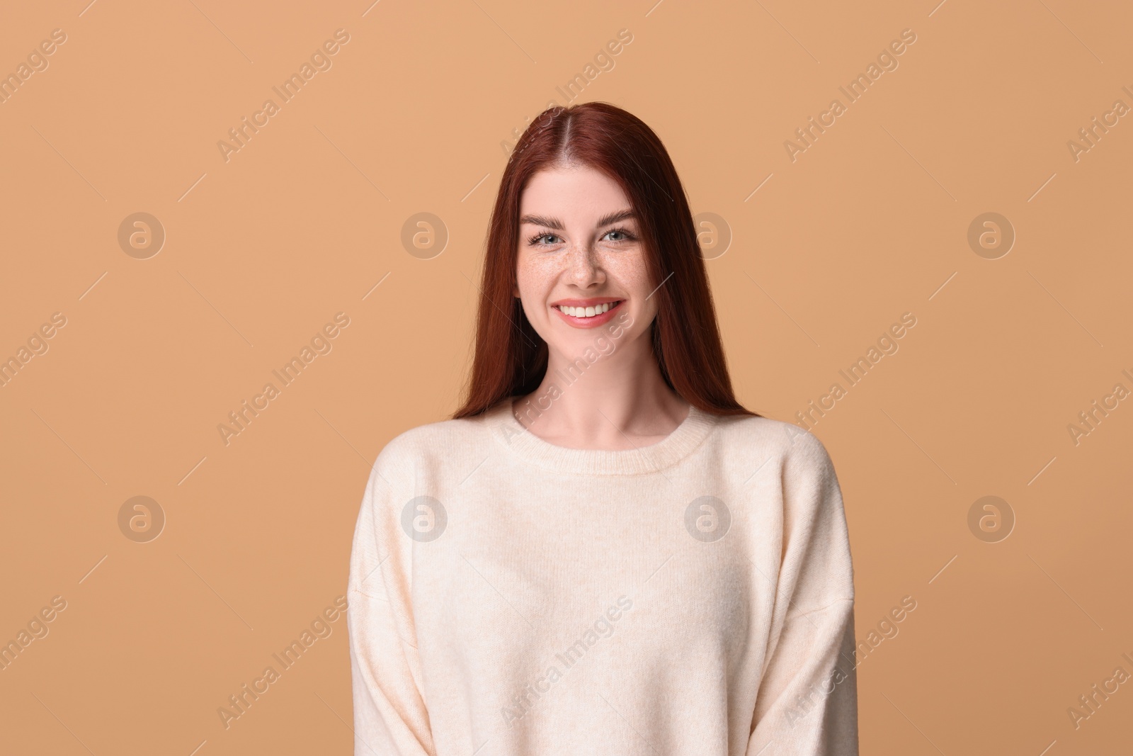 Photo of Portrait of smiling woman on beige background