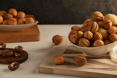 Freshly baked walnut shaped cookies on white wooden table. Homemade pastry filled with caramelized condensed milk