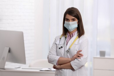 Photo of Pediatrician with protective mask and stethoscope in clinic