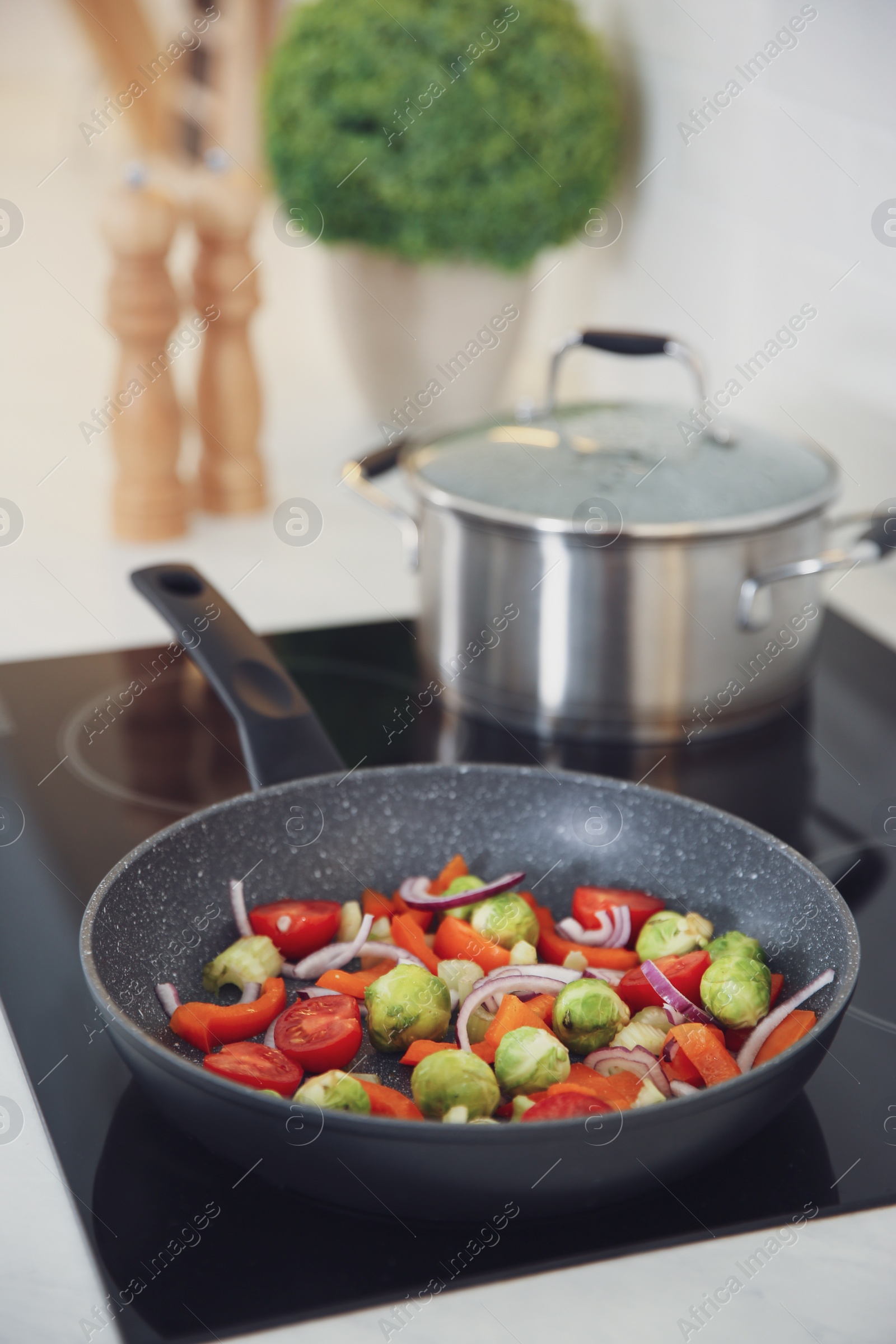 Photo of Vegetables frying in pan on stove. Cooking at home