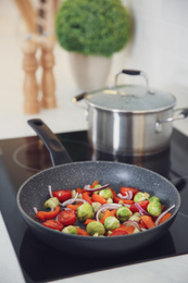 Photo of Vegetables frying in pan on stove. Cooking at home