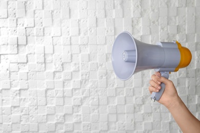 Photo of Woman holding megaphone on white background