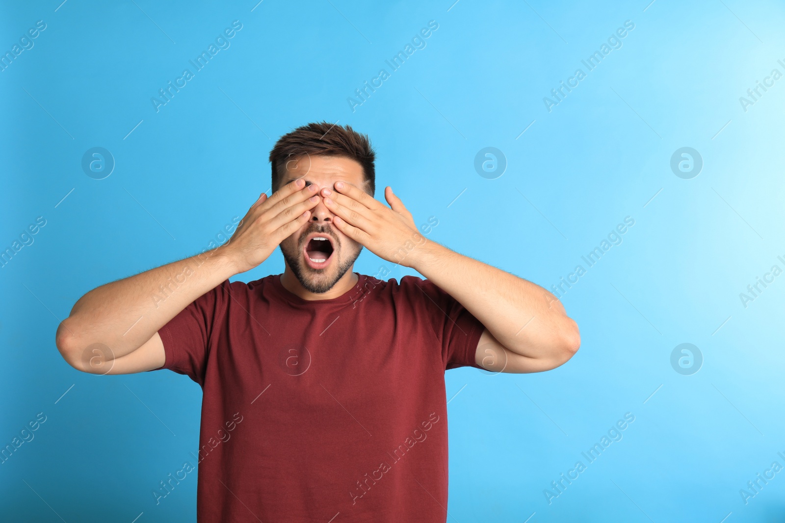 Photo of Young man being blinded on blue background