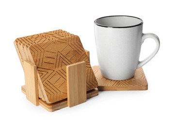 Photo of Mug and stylish wooden coasters on white background