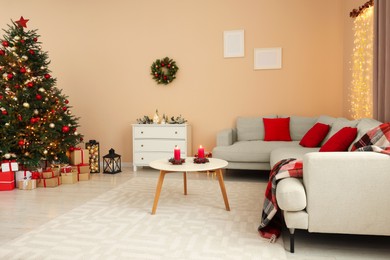 Christmas interior. Beautiful tree decorated with baubles in room with cozy furniture