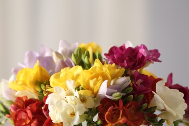 Beautiful bouquet of spring freesia flowers on blurred background, closeup