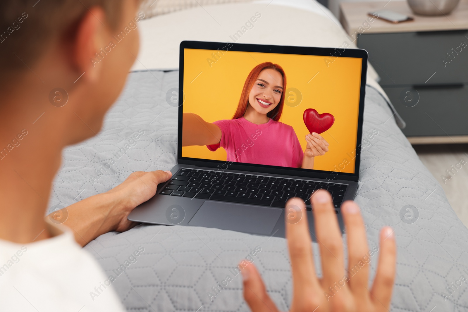 Image of Long distance love. Man having video chat with his girlfriend via laptop at home, closeup