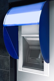 Photo of Modern color automated teller cash machine outdoors