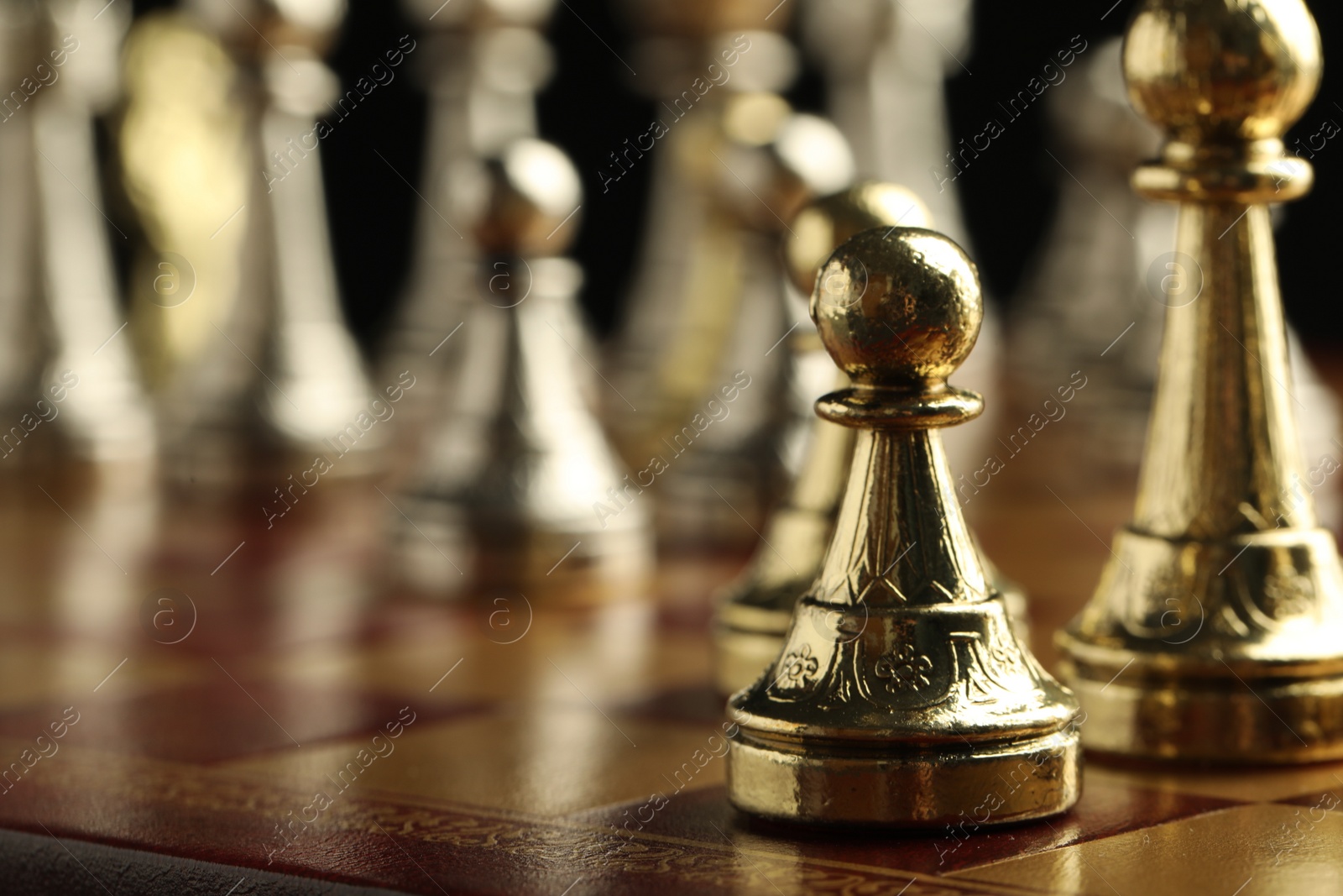 Photo of Chessboard with game pieces on black background, closeup. Space for text