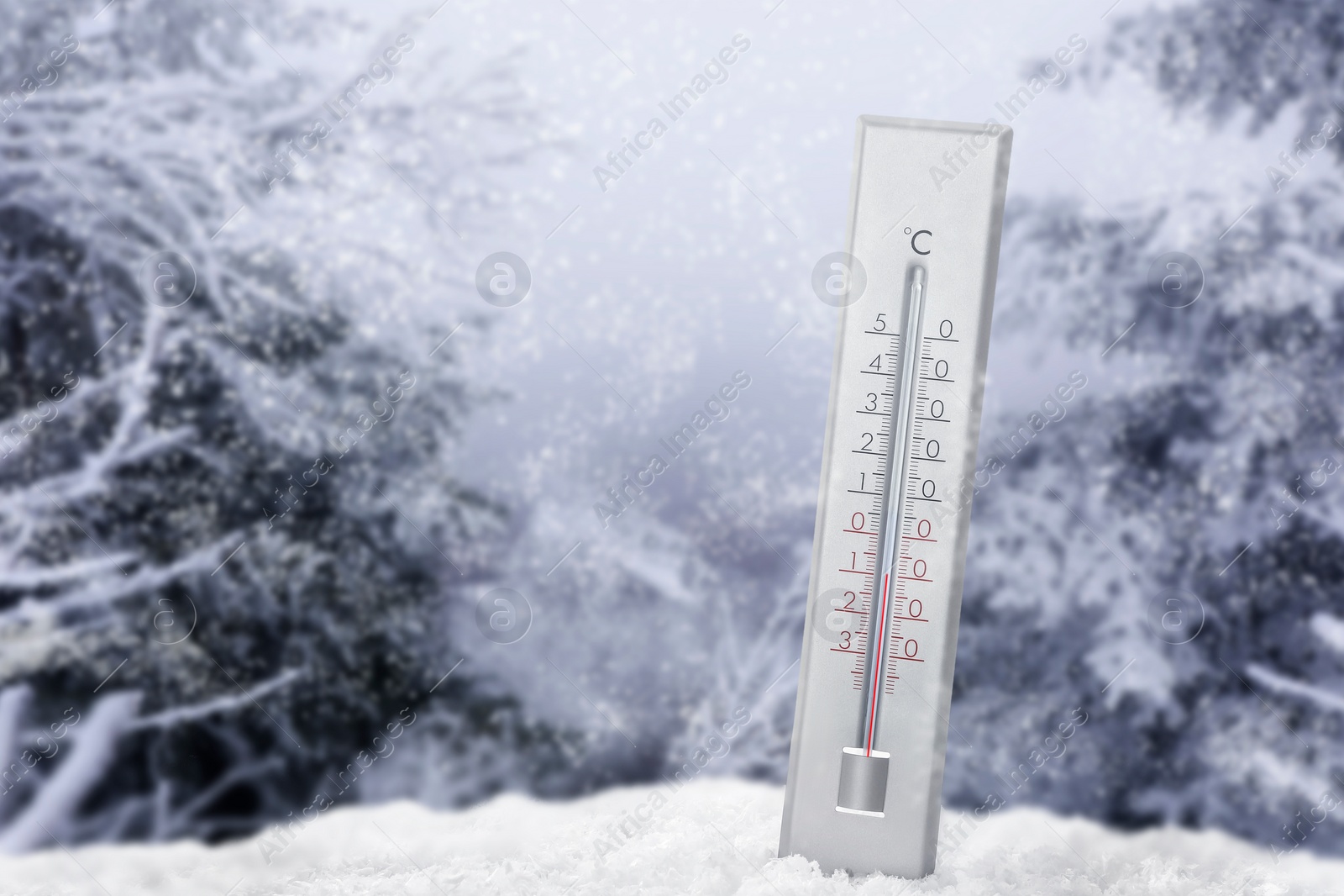 Image of Thermometer in snow showing temperature below zero outdoors on winter day