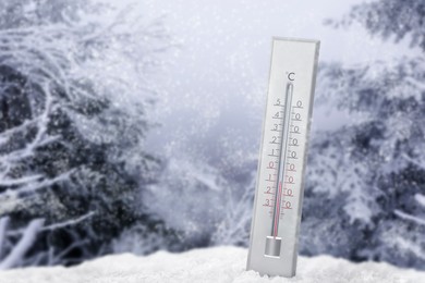 Thermometer in snow showing temperature below zero outdoors on winter day