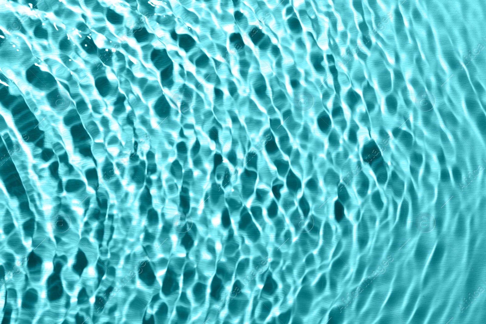 Image of Rippled surface of clear water on light blue background, top view