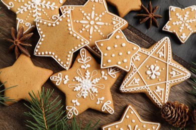 Photo of Tasty Christmas cookies, fir branch and anise on black table, flat lay