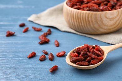 Photo of Dried goji berries on blue wooden table