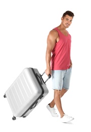 Photo of Young man walking with suitcase on white background