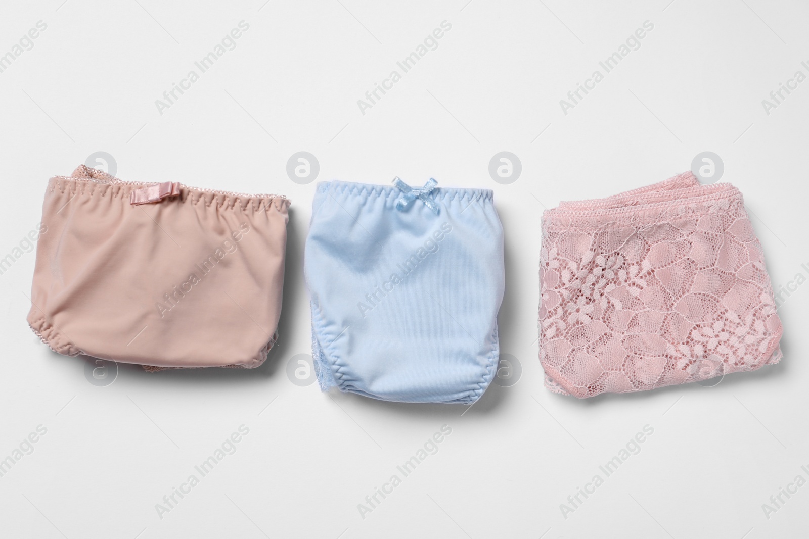 Photo of Stylish folded women's underwear on white background, flat lay