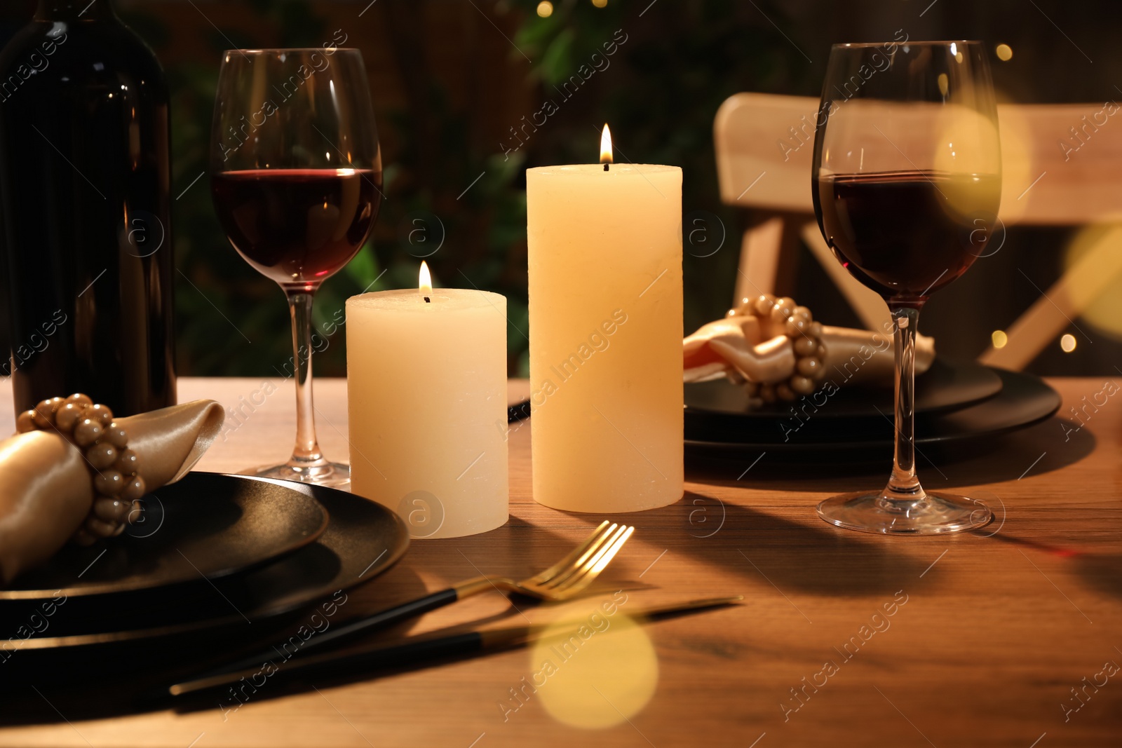 Photo of Beautiful table setting with glasses of wine and candles. Romantic dinner for Valentine's day
